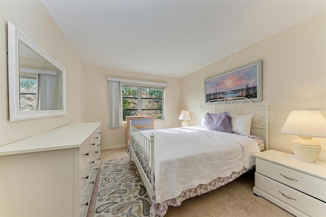 bedroom with light carpet and multiple windows