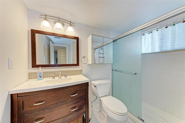 bathroom featuring tasteful backsplash, a textured ceiling, toilet, a shower with shower door, and vanity