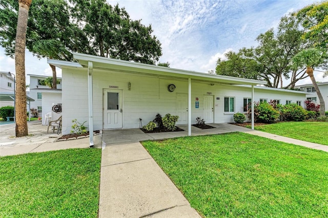 ranch-style house featuring a front yard and a carport