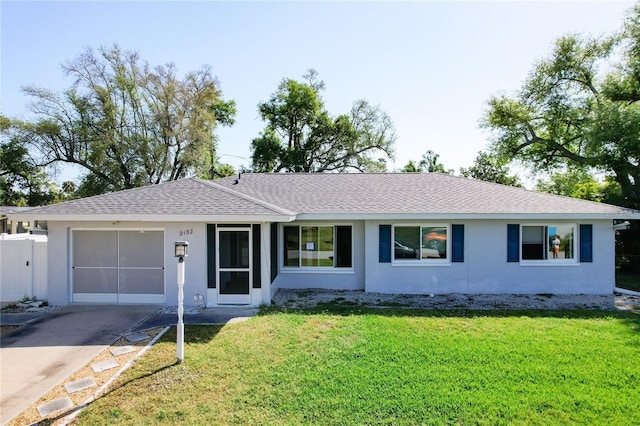 ranch-style house with a garage and a front lawn