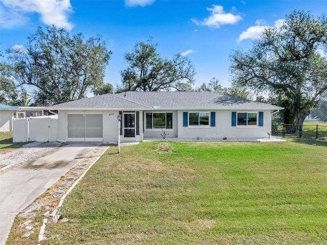 single story home featuring a garage and a front yard