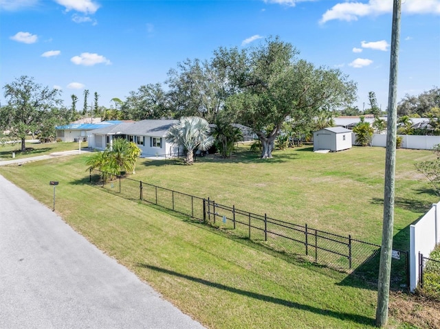 view of yard with a rural view and a storage shed