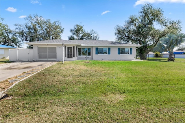 ranch-style home featuring a garage and a front lawn