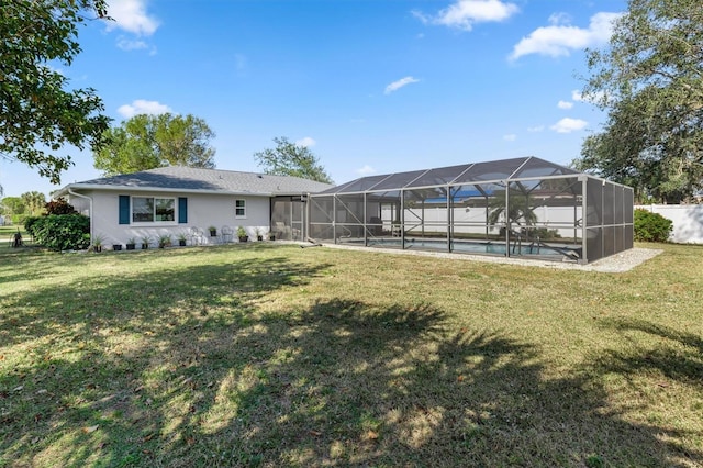 rear view of property with a lanai and a lawn