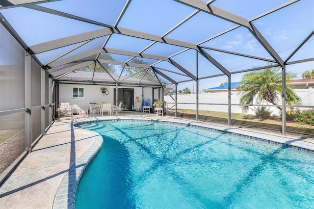 view of swimming pool with a lanai and a patio