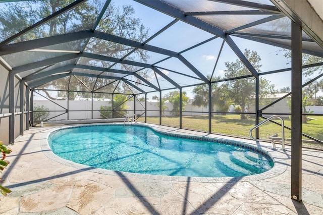 view of pool with a yard, a lanai, and a patio area