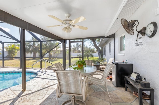 sunroom featuring ceiling fan