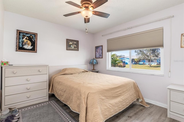 bedroom featuring hardwood / wood-style floors and ceiling fan