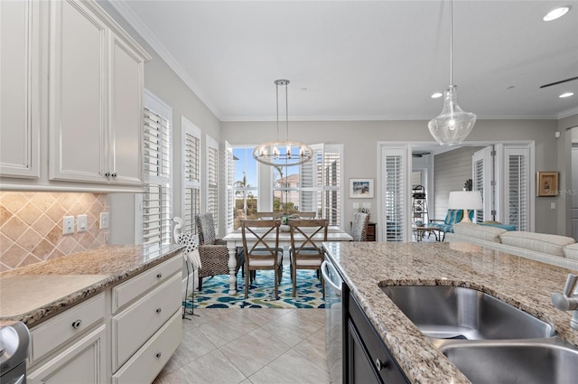 kitchen with sink, decorative light fixtures, and white cabinets