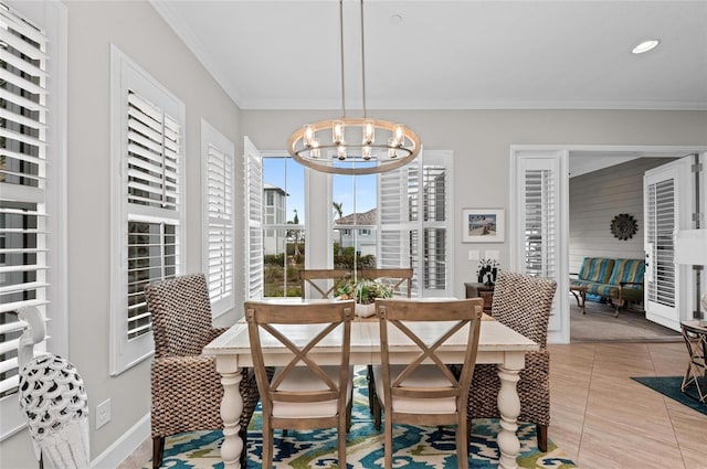 tiled dining area featuring crown molding and a chandelier