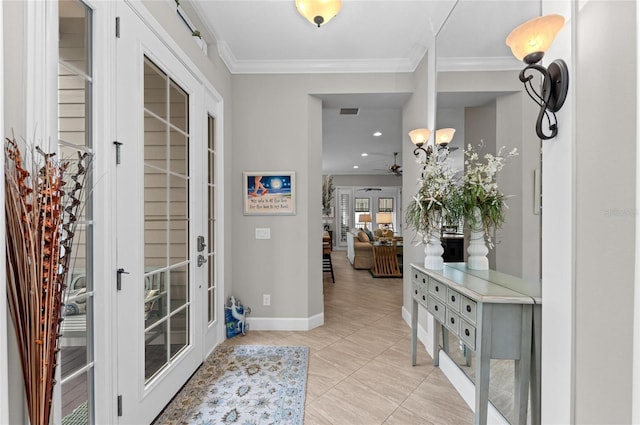 tiled entryway with crown molding and french doors