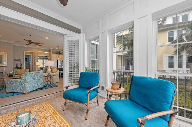 sunroom / solarium featuring plenty of natural light and ceiling fan