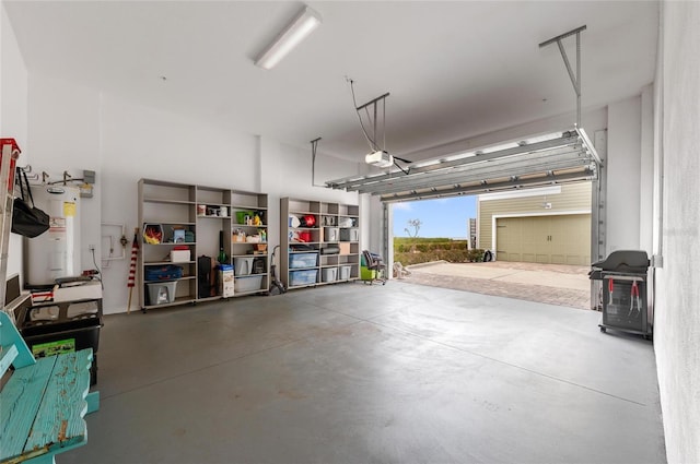 garage with a garage door opener and electric water heater