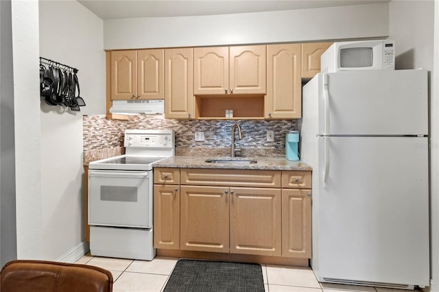 kitchen featuring light tile patterned floors, white appliances, sink, and backsplash