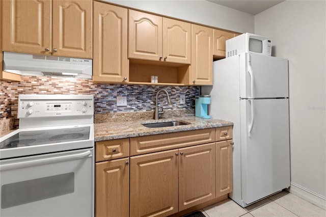 kitchen featuring sink, tasteful backsplash, light tile patterned floors, white appliances, and light stone countertops