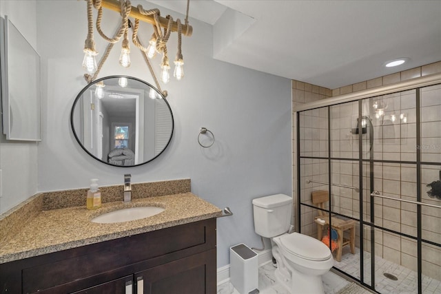 bathroom featuring an enclosed shower, vanity, and toilet