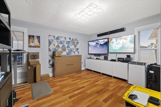 interior space with a textured ceiling and light wood-type flooring