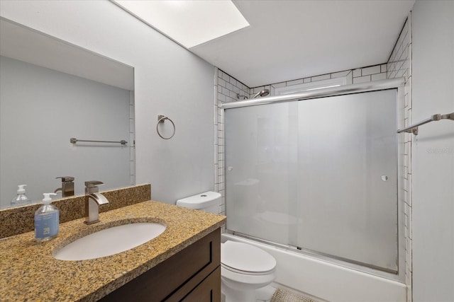 full bathroom featuring vanity, toilet, and combined bath / shower with glass door