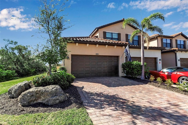 mediterranean / spanish-style house with a garage