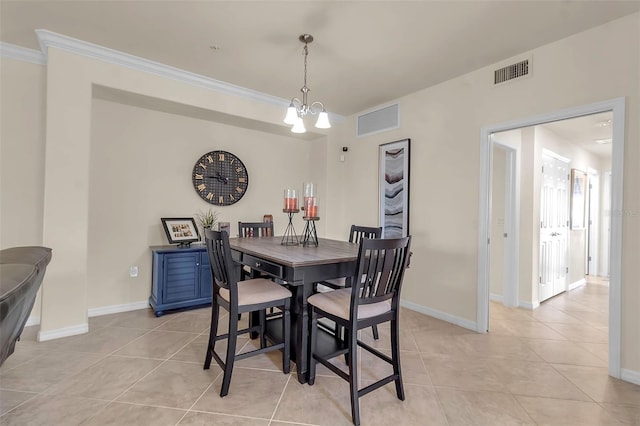 tiled dining room with an inviting chandelier and crown molding