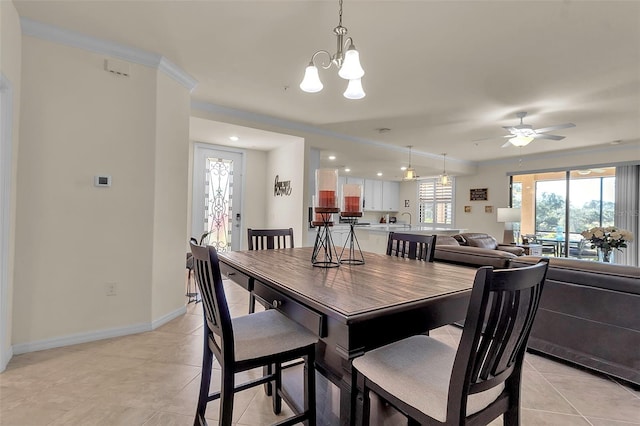 dining area featuring light tile patterned flooring, ceiling fan with notable chandelier, and crown molding