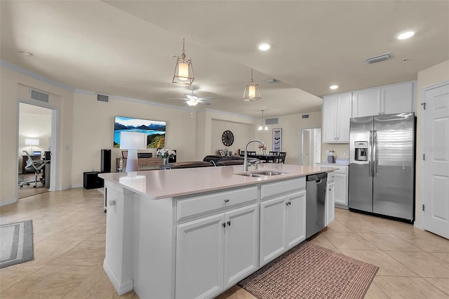 kitchen with sink, ceiling fan, a kitchen island with sink, stainless steel appliances, and white cabinets