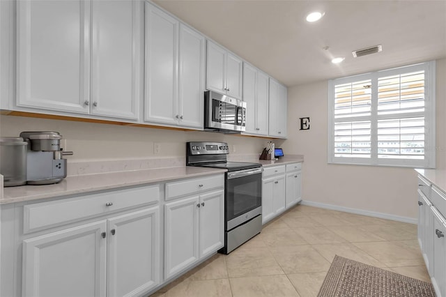 kitchen featuring white cabinets and appliances with stainless steel finishes