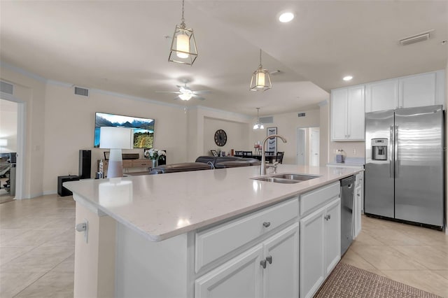 kitchen featuring white cabinetry, sink, stainless steel appliances, and a center island with sink