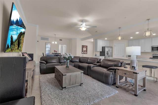 tiled living room featuring ceiling fan and ornamental molding