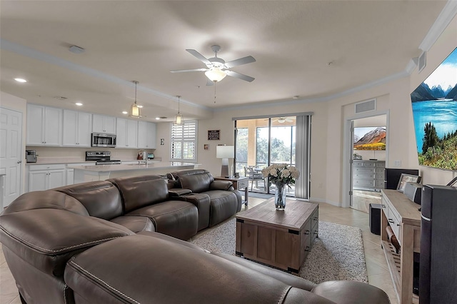 living room with sink, crown molding, ceiling fan, and light tile patterned flooring