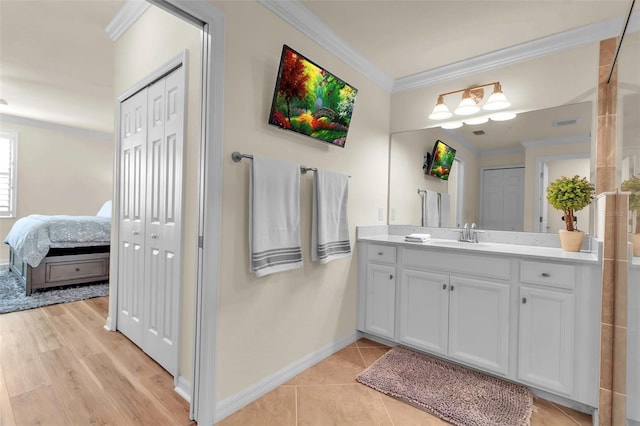 bathroom featuring vanity, tile patterned flooring, and crown molding