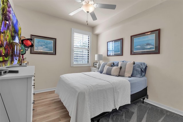 bedroom with light hardwood / wood-style flooring and ceiling fan