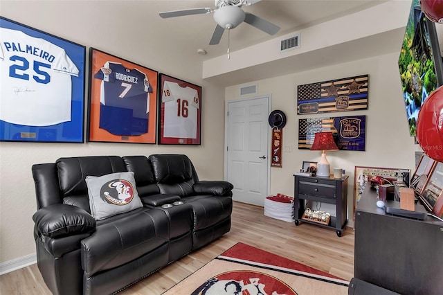 living room featuring ceiling fan and light hardwood / wood-style floors