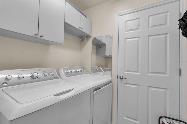 laundry area with cabinets and washing machine and dryer