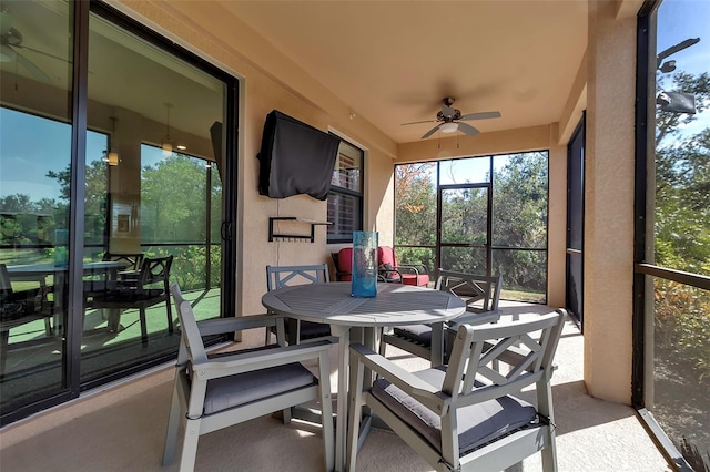 sunroom / solarium featuring ceiling fan