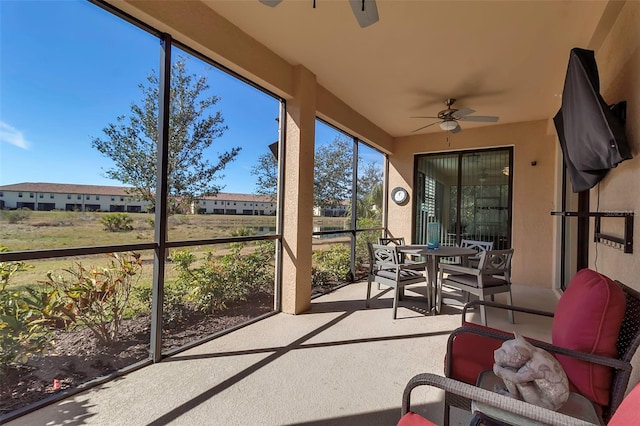 sunroom / solarium featuring ceiling fan