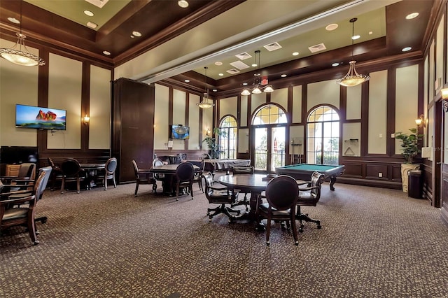 game room featuring a towering ceiling, ornamental molding, a tray ceiling, and carpet floors