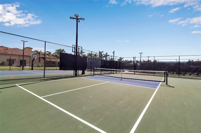 view of tennis court featuring basketball court