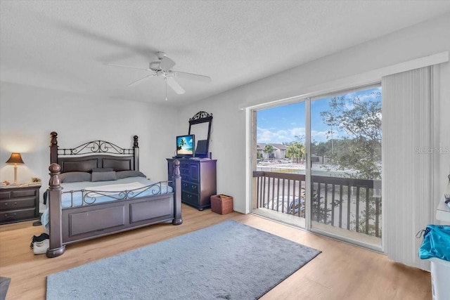 bedroom with light wood-type flooring, a textured ceiling, ceiling fan, and access to outside