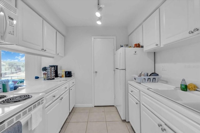 kitchen with white cabinets, white appliances, sink, and light tile patterned flooring