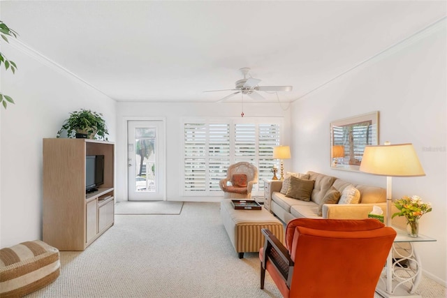 carpeted living room with ceiling fan, crown molding, and a healthy amount of sunlight