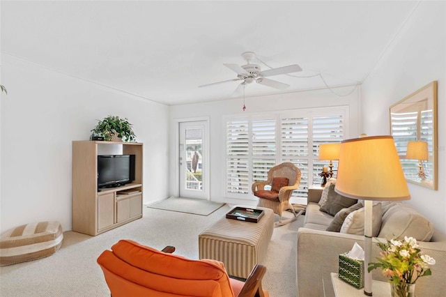 living room with ceiling fan, plenty of natural light, and light carpet