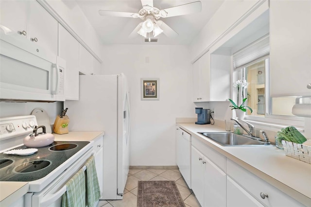 kitchen featuring sink, white cabinetry, white appliances, and light tile patterned floors