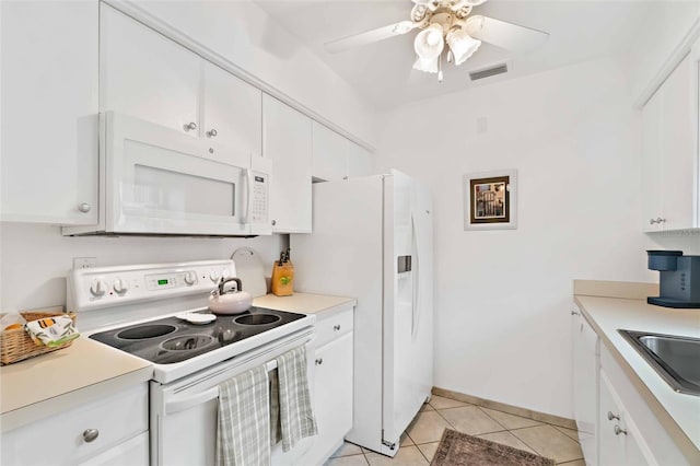 kitchen featuring white appliances, light tile patterned floors, white cabinets, sink, and ceiling fan