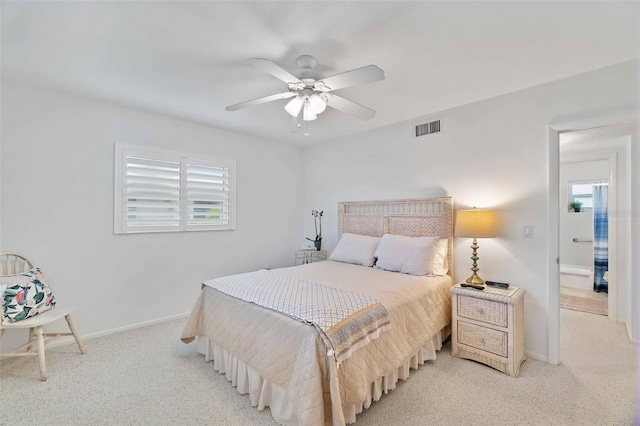 carpeted bedroom featuring multiple windows and ceiling fan