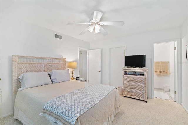 carpeted bedroom featuring ceiling fan and ensuite bathroom