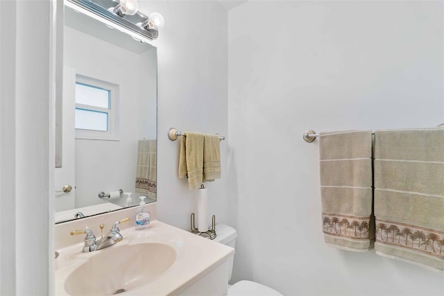 bathroom featuring toilet and vanity