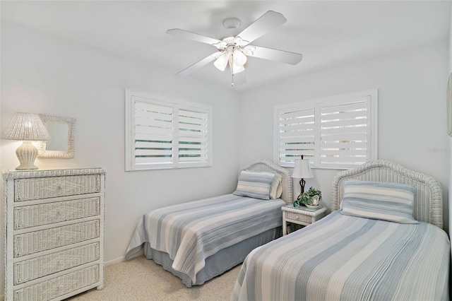 bedroom featuring ceiling fan and light carpet