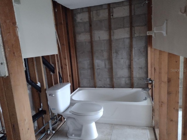 bathroom featuring toilet, tile patterned floors, and a bathtub