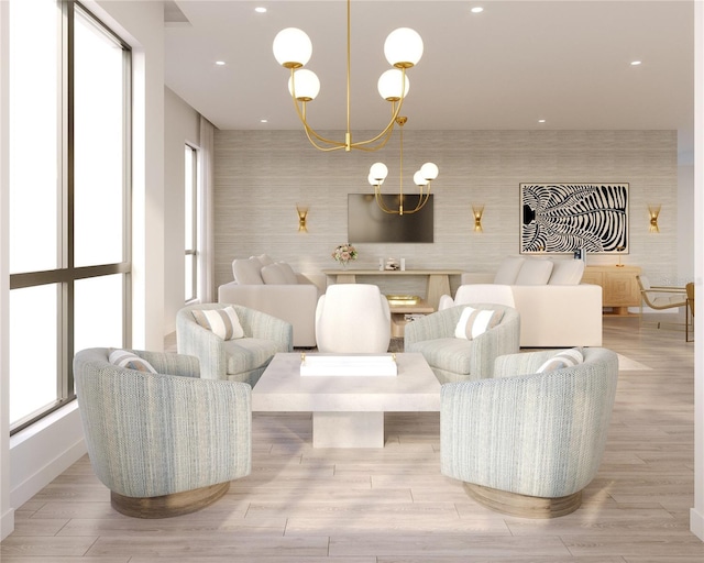 living room with a wealth of natural light, light hardwood / wood-style flooring, and an inviting chandelier